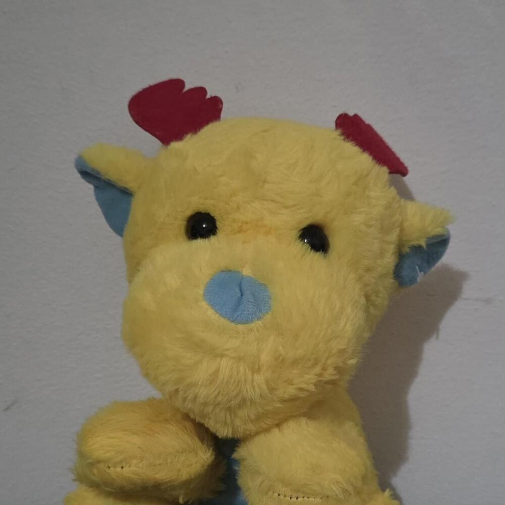 Yellow plush reindeer with red antlers and blue nose #reindeer #christmas